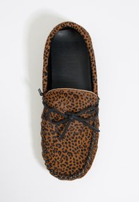 Mocasines de estampado de leopardo marrón con cordones negros, con un contorno cosido y una plantilla negra suave. Diseño clásico de deslizamiento.