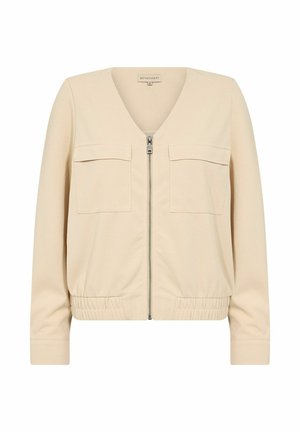 Beige zip-up jacket with a V-neckline, two front pockets, and elastic waistband. Made from smooth fabric with a structured fit.