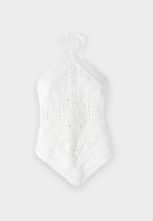 White halter top made from textured fabric, featuring intricate lace and geometric cutout patterns, with a triangular shape and lace trim.