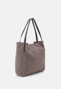 Graue Wildleder-Tragetasche mit zwei dunklen Lederträgern. Sie verfügt über eine glatte Textur und genähte Details entlang der Seiten. Offenes Oberteil-Design.