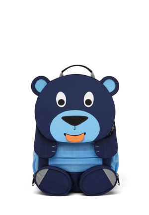 Blue and navy bear-shaped backpack with large eyes, orange tongue, and padded ears. Features zippers, round pockets, and a textured front.