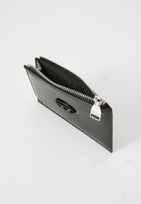 Black leather wallet with a textured finish, zip closure, and logo detail. Slim design with a smooth interior lining.