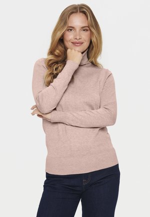 Light pink turtleneck sweater in a soft knit material, featuring long sleeves and a fitted ribbed hem, paired with dark jeans.