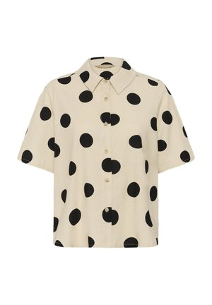 Camisa beige de manga corta con botones, con grandes lunares negros y cuello puntiagudo.