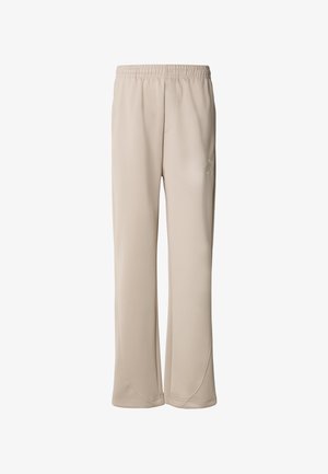 Beige träningsbyxor i mjukt, lätt tyg. Har ett elastiskt midjeband och subtila sömdetaljer längs sidorna.