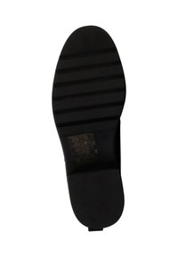 Black shoe sole with textured surface, featuring horizontal grooves and a small emblem. Rounded toe and flat heel design.