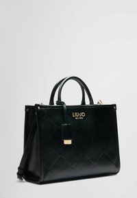 Borsa a tracolla in pelle nera con motivo trapuntato, doppi manici, una tracolla removibile e hardware in tonalità dorata con il logo.