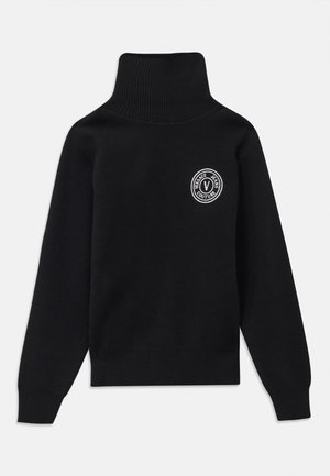 Black turtleneck sweater made of knit fabric, featuring a ribbed collar and cuffs, with a circular white logo on the upper left chest.