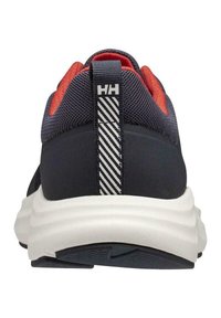 Chaussure de sport marine avec accents rouges, tige en maille texturée, semelle blanche rembourrée et boucle de talon rayée arborant le logo.