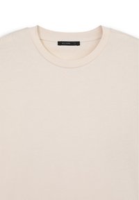 T-shirt in cotone beige chiaro con scollo rotondo. Presenta maniche corte e una texture morbida e liscia. L'etichetta riporta "ALLIOPE L."