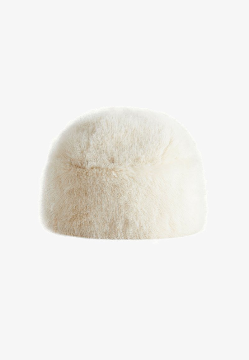 Soft, fluffy off-white round fur hat with a short, dense pile and subtle seam detail across the surface.