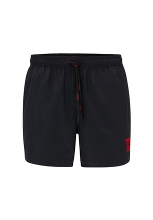 Pantaloni da mare neri realizzati in tessuto leggero. Presentano un elastico in vita con cordino e una toppa rossa con il logo sulla gamba sinistra.