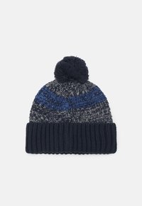 Knitted beanie in navy blue with a textured gray and blue pattern, finished with a fluffy pom-pom on top and a ribbed cuff.