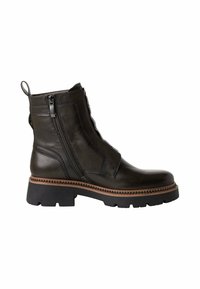 Bottines en cuir noir à zip latéral, avec une semelle noire robuste et une couture décorative marron. Elles possèdent une languette à l'arrière.