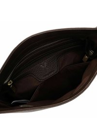 Brown leather bag interior with a textured panel and zipper. Smooth fabric lining and internal pockets enhance organization.