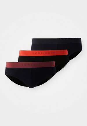 Drie paar aansluitende slipjes in donkere kleuren: marineblauw, zwart en bordeaux, met contrasterende elastische taillebanden met "Schiesser" branding.