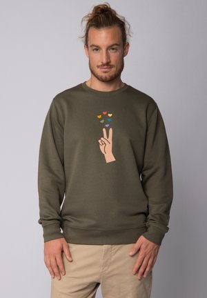 Olive green sweatshirt with long sleeves, featuring a hand gesture and colorful hearts printed on the front. Soft, textured fabric.