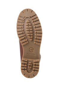 Semelle de chaussure en caoutchouc marron avec des motifs texturés et un motif ovale. Inclut des nervures marquées pour l'adhérence et un logo en relief au centre.
