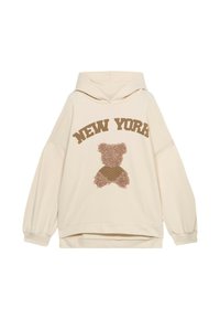 Haut à capuche couleur crème avec le texte « NEW YORK » au-dessus d'un graphique de teddy bear. Le détail de l'ours est un mélange de textures duveteuses et matelassées.