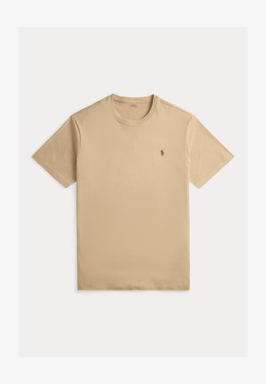 Beige lyhythihainen pyöreäkauluksinen T-paita, jossa vasemmassa rinnassa pieni kirjailtu Polo Ralph Lauren -logo.