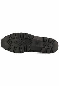 Suola di scarpa in gomma nera con una superficie testurizzata, caratterizzata da profondi solchi, un motivo a stella e un logo sul tallone per aderenza e durata.