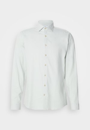 Heled roheline pikkade varrukatega särk, mis on valmistatud pehmest kangast. Omab klassikalist krae, esi-nupplahendust ja nupuga mansette.