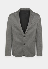 Blazer s vzorem houndstooth v černé a bílé barvě, s dvouknoflíkovým zapínáním, klopovými límci a dvěma předními kapsami. Hladká textura.