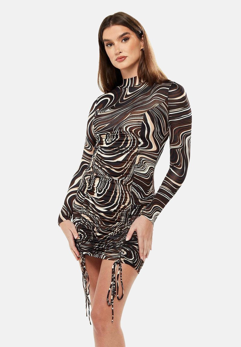 Long-sleeve dress in brown, beige, and black swirl pattern. Features ruching at the sides and adjustable tie accents at the hem.