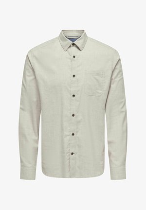 Heledhall hallidega pikkade varrukatega nööbiga särgiga, millel on krae, rinnatasku ja tumedad nööbid struktureeritud kangaste taustal.