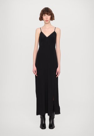 Black maxi dress with a V-neck, lace trim, and thin shoulder straps. Features a side slit, smooth texture, and a flowing silhouette.