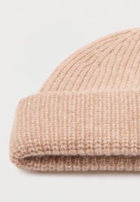 Pink knitted beanie with a ribbed texture and a folded cuff, made of soft yarn, featuring varying shades and subtle highlights.