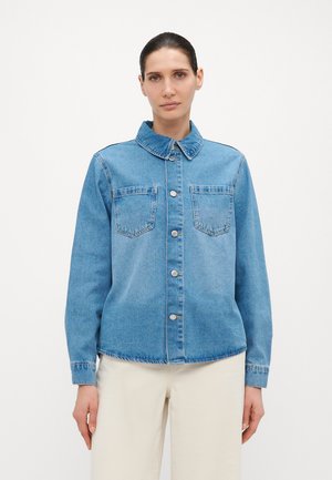 Light blue denim jacket with a collared neckline, front buttons, and two chest pockets. Features long sleeves and a straight cut design.