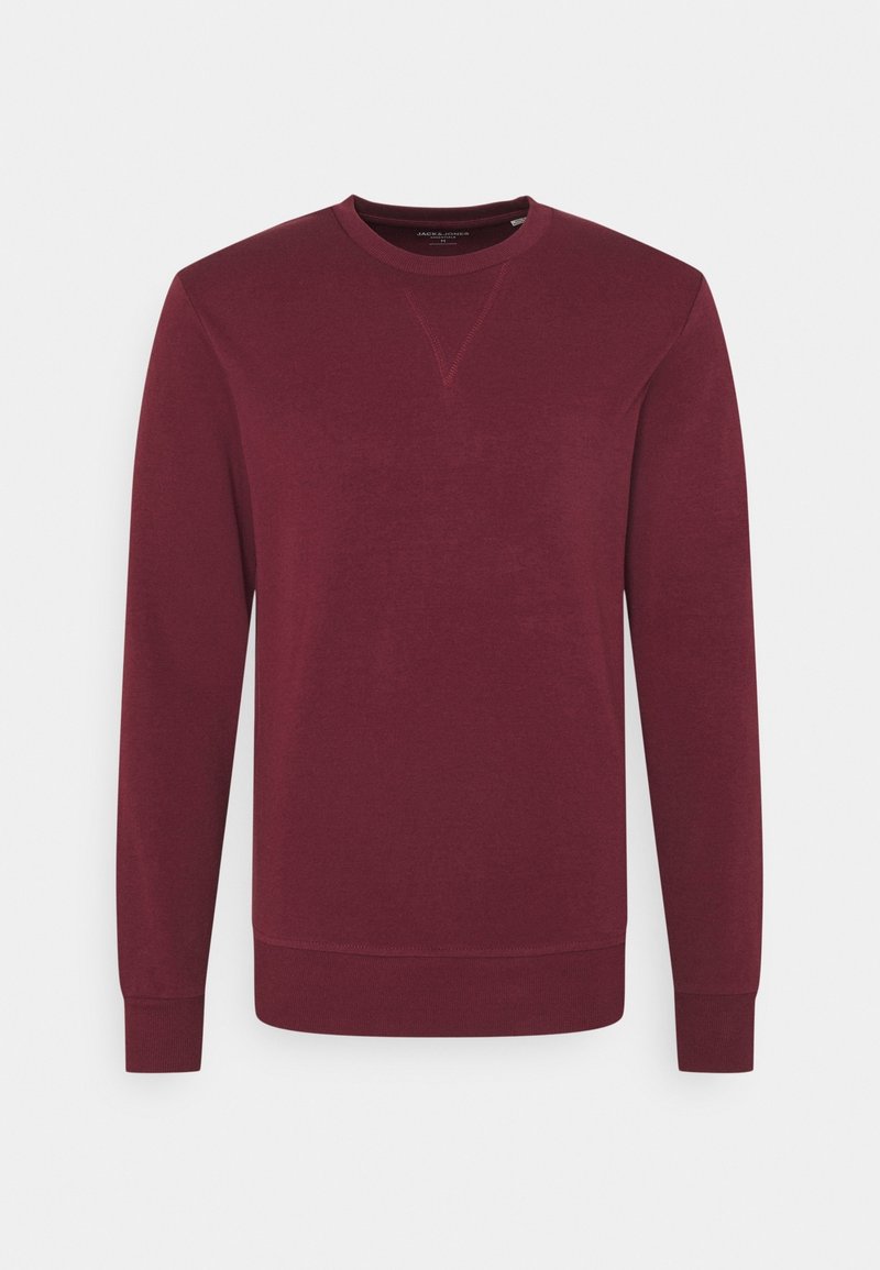 Sweatshirt bordeaux con maniche lunghe, scollo a girocollo e un leggero cucito a trama lungo la cucitura della spalla. Tessuto morbido in misto cotone.