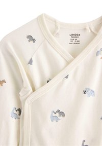 Baumwoll-Einsteigerschaft für Neugeborene in Creme mit hellen Dinosaurier-Drucken in Grau und Braun. Verfügt über ein Wickeldesign mit Druckknopfverschlüssen an der Seite.