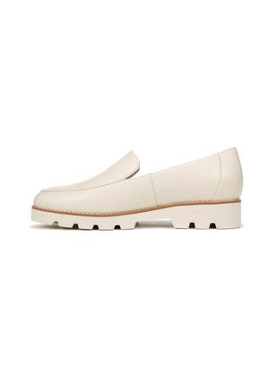 Beige leather loafers with a smooth texture, featuring a rounded toe, subtle stitching detailing, and a chunky white sole with grooves.