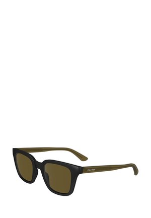 Black square-framed sunglasses with brown lenses. Olive green temples feature "Calvin Klein" branding, highlighting contrast in color and design.