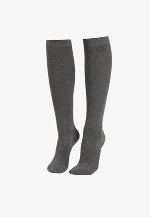 Calcetines grises hasta la rodilla hechos de un suave tejido de punto. Textura lisa con un color sólido y un puño elástico en la parte superior.