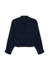 Navy blue cropped shirt with long sleeves, two chest pockets, and a tie closure featuring a metallic ring accessory. Smooth fabric texture.