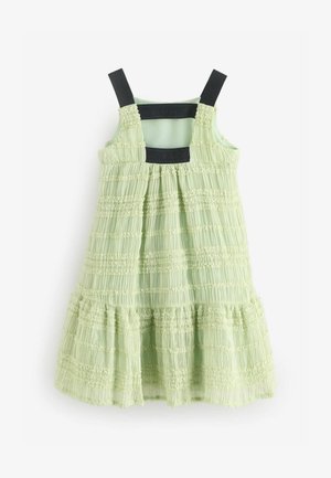 Vihreä kesämekko, jossa on rypytetty pinta, mustat säädettävät olkaimet ja kerroksellinen hameosa. Liukas kangas kauttaaltaan.