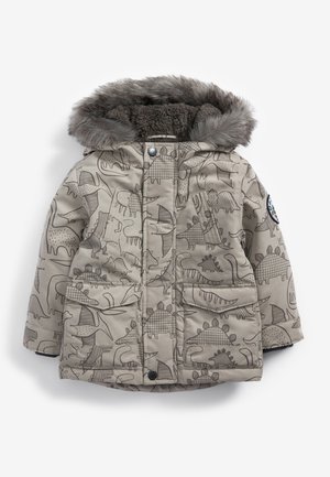 Veste d'hiver beige pour enfants avec des motifs de dinosaures, deux poches avant, une capuche doublée de fourrure et un écusson sur la manche gauche.