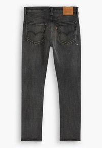 Vaqueros de mezclilla negra con un ajuste slim, con dos bolsillos traseros, un desgaste sutil y una etiqueta de cuero marrón en la cintura.