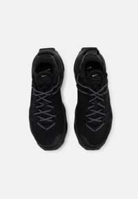 Paire de chaussures de course Nike noires avec des lacets à motifs et des semelles rembourrées, vues de dessus sur fond blanc.