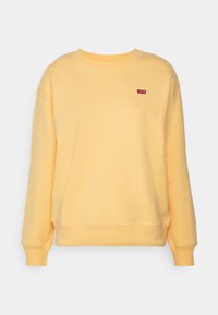 Sudadera amarilla de tejido suave con un corte relajado, puños y dobladillo acanalados. Presenta un pequeño logo rojo de Levi's en el lado izquierdo del pecho.