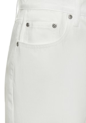 White denim jeans feature a close-up of the back pocket with silver hardware accents and a smooth texture.