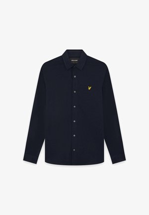 Marineblaue langärmlige Hemdbluse mit Knopfleiste, spitzem Kragen und kleinem gelbem Adler-Logo auf der linken Brustseite.