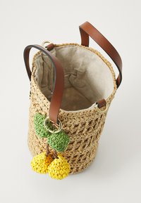 Woven straw basket with a beige fabric lining, featuring brown leather straps and green/yellow crochet fruit embellishments.