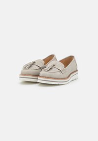 Light gray loafers with a textured upper, featuring a decorative tassel and a white rubber sole with a brown accent stripe.