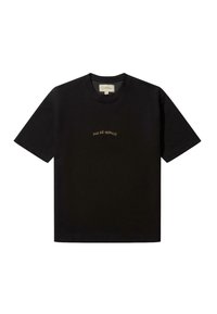 Black cotton t-shirt with short sleeves and a crew neck; features “PAS DÉ MONACO” in gold embroidery across the chest.