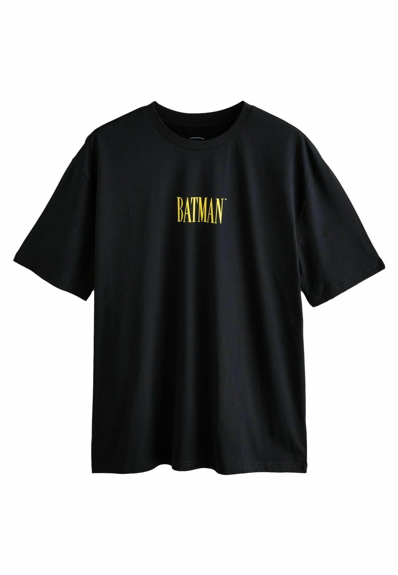 Čierne bavlnené tričko s krátkymi rukávmi a žltým logom "BATMAN" v tučnom písme na prednej strane. Jednoduchý, neformálny dizajn.