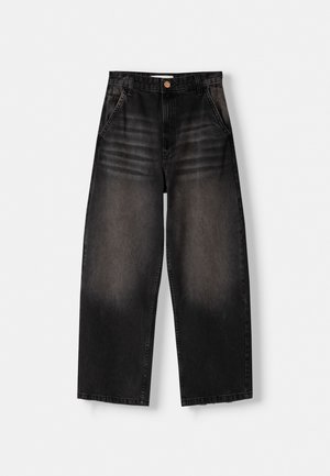 Black wide-leg jeans in a faded wash with front pockets, copper button, and stitching details. Made from denim with a soft texture.